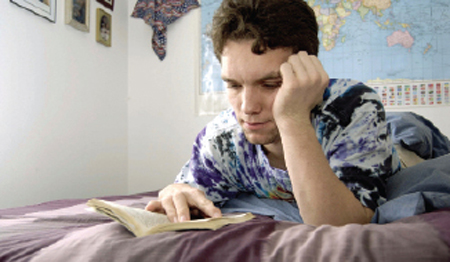 Image: Student reading on bed