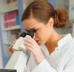 Image: Woman looking into microscope
