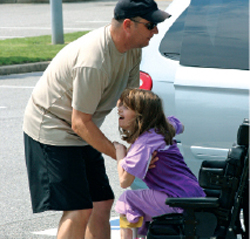 Image: Male carer helping girl