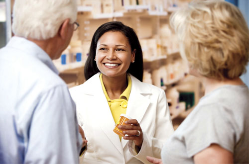 Image: chemist talking to customers