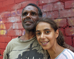 Image: Smiling couple in front of wall