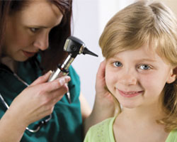 Image: Doctor looking in childs ear