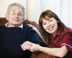 Image: Carer holding man's hand