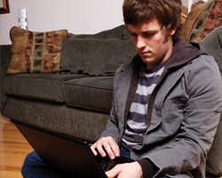 Image: Adolescent male using a laptop
