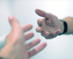 Image: Hands reaching for each other