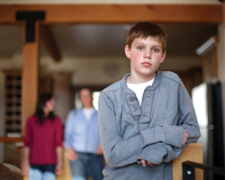 Image: Boy leaning on a handrail
