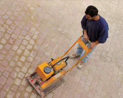 Image: Man using machinery on paving 