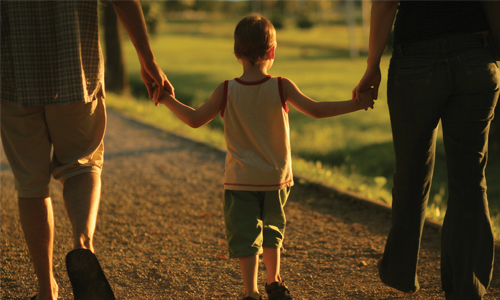 Photo: Child holding parents hands