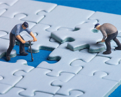 Image: animated workers on a jigsaw puzzle