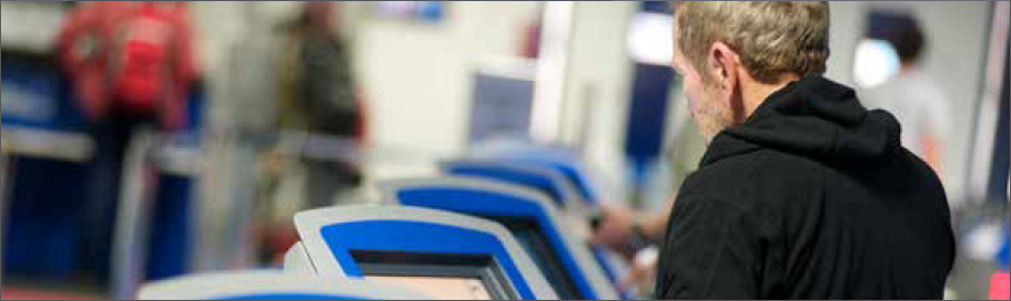 Photo of a man using the airport electronic passport control system.