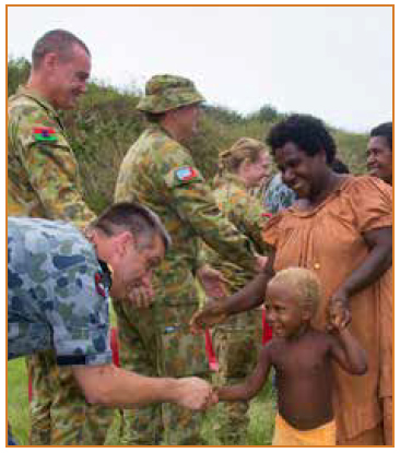 Photo of peacekeeping personnel greeting members from an indigenous community.