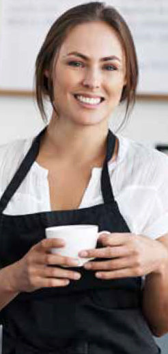 Charlotte holding a cup of coffee